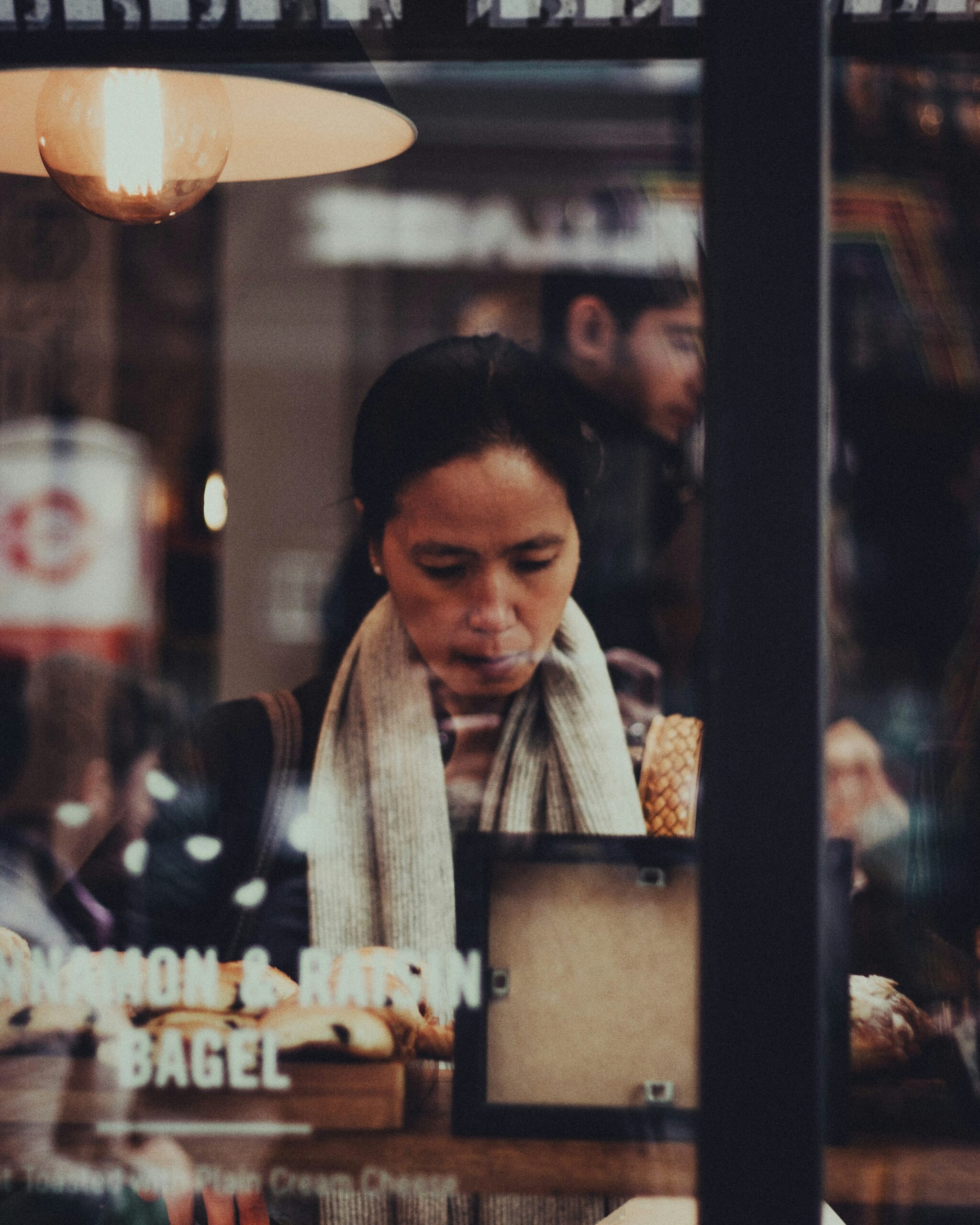 View of woman sitting at the counter a bagel shop.