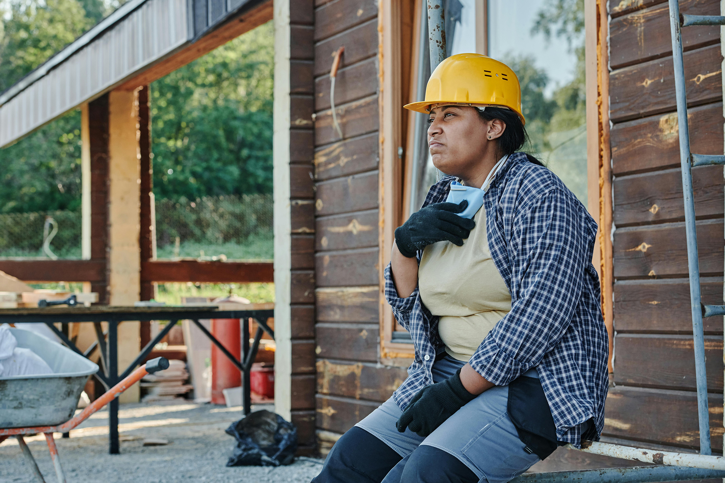 Woman in Blue and White Checkered Shirt and a Hardhat