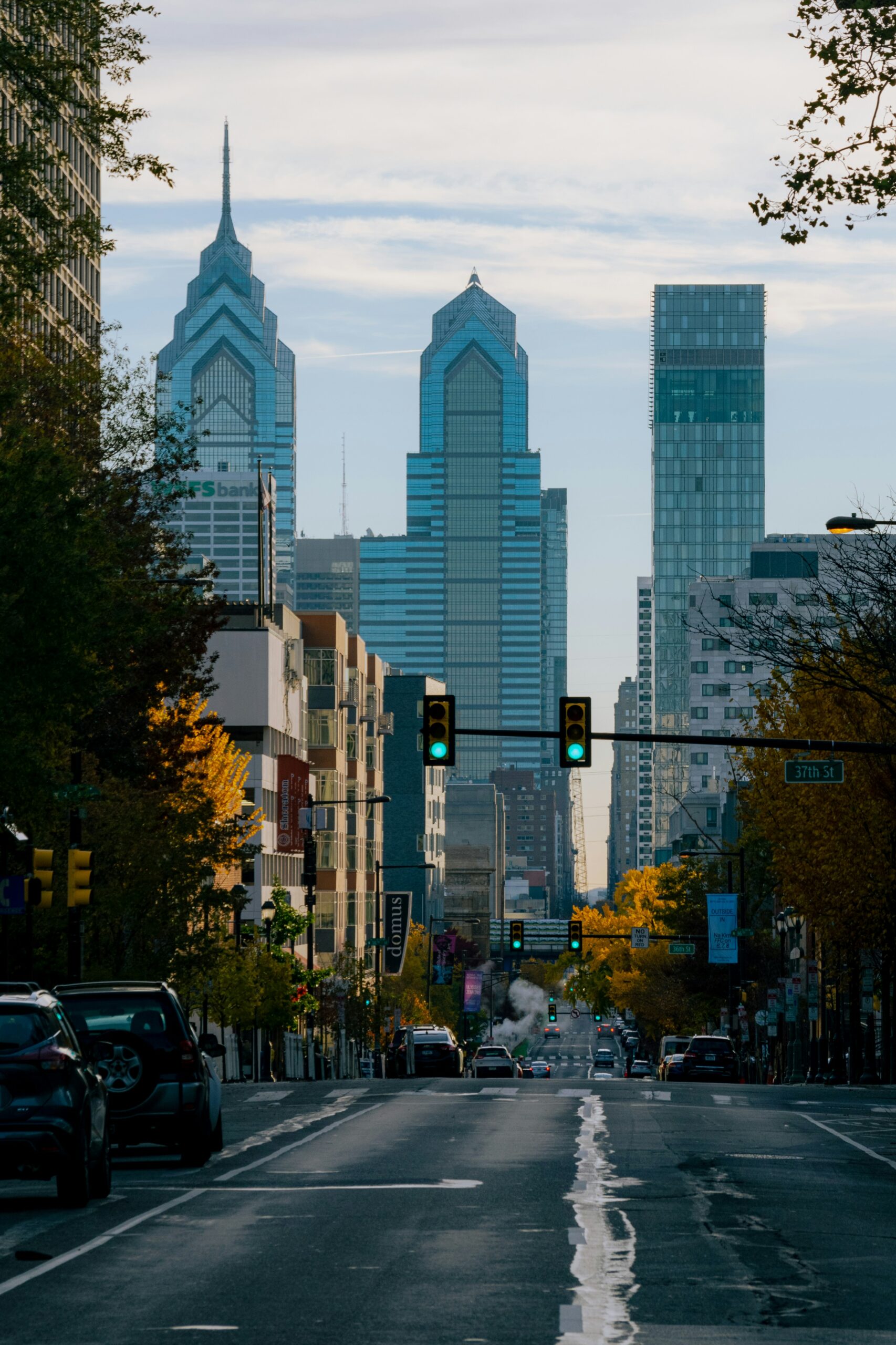 a traffic light in Philadelphia with tall buildings in the background