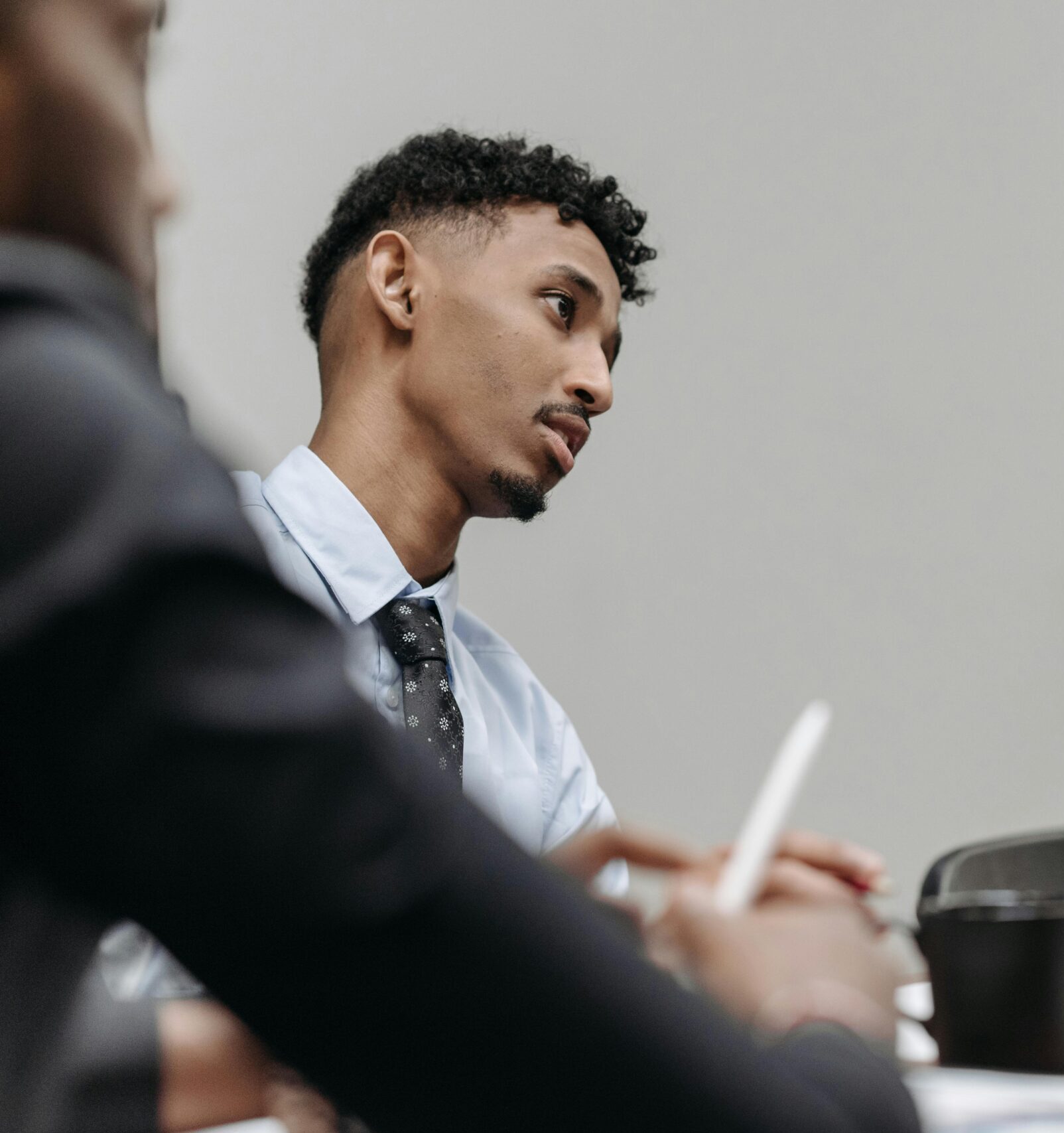 Man with Black Necktie Sitting Beside Woman Wearing Hijab